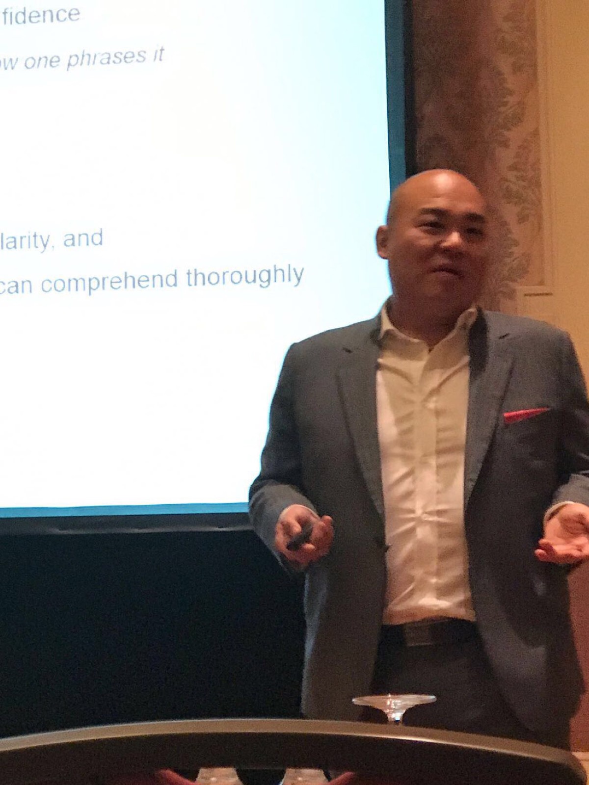 Marcus Lim presenting from the front of the room