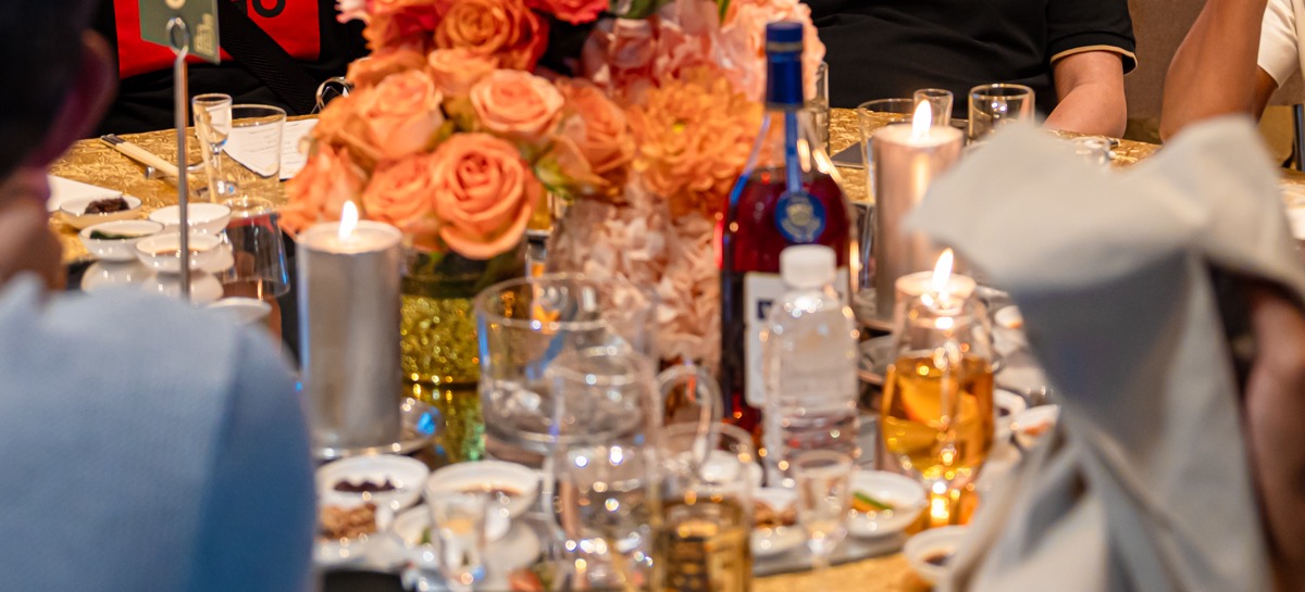 Gold table settings, florals and candlelight